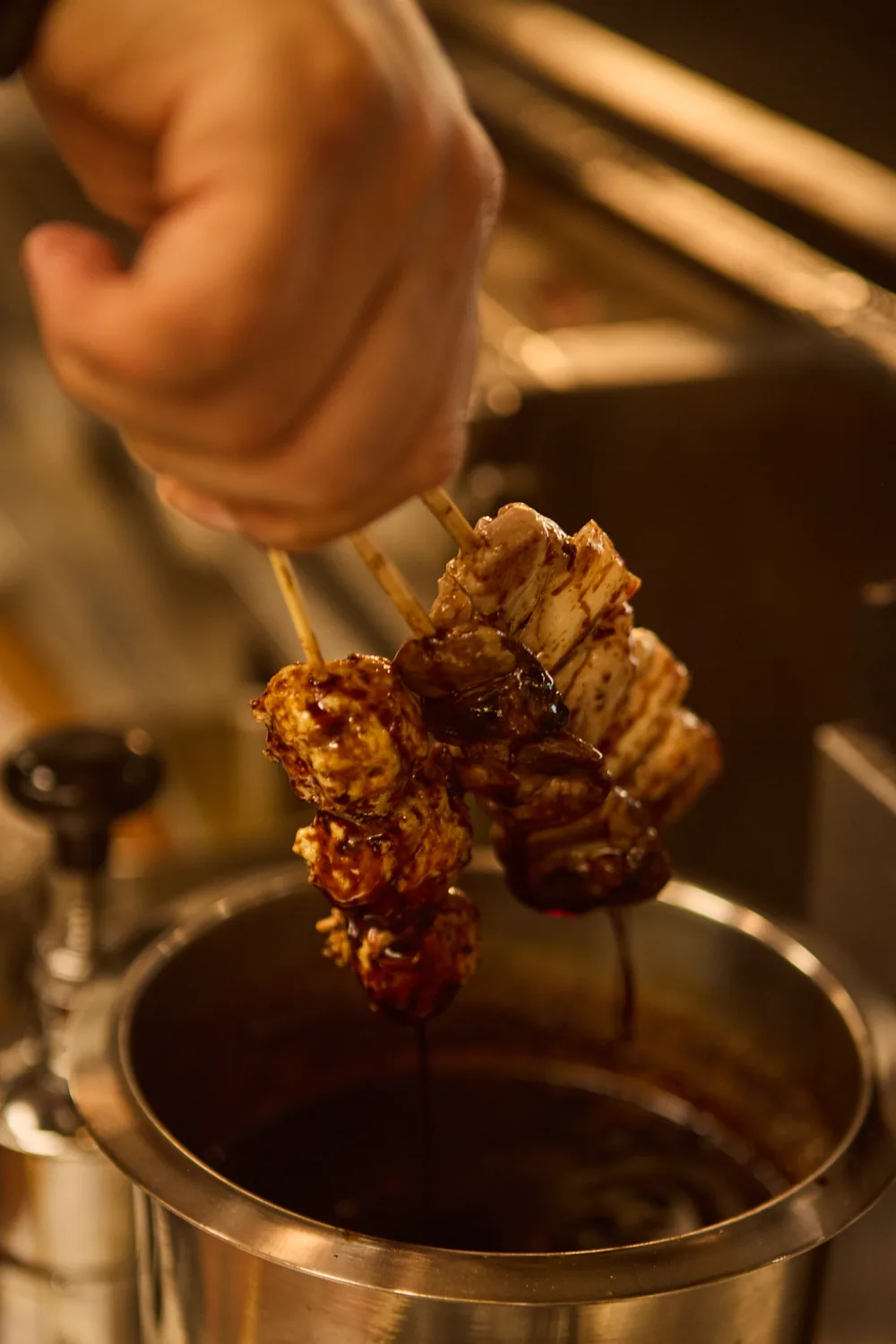 Skewers brushed with tare by hand