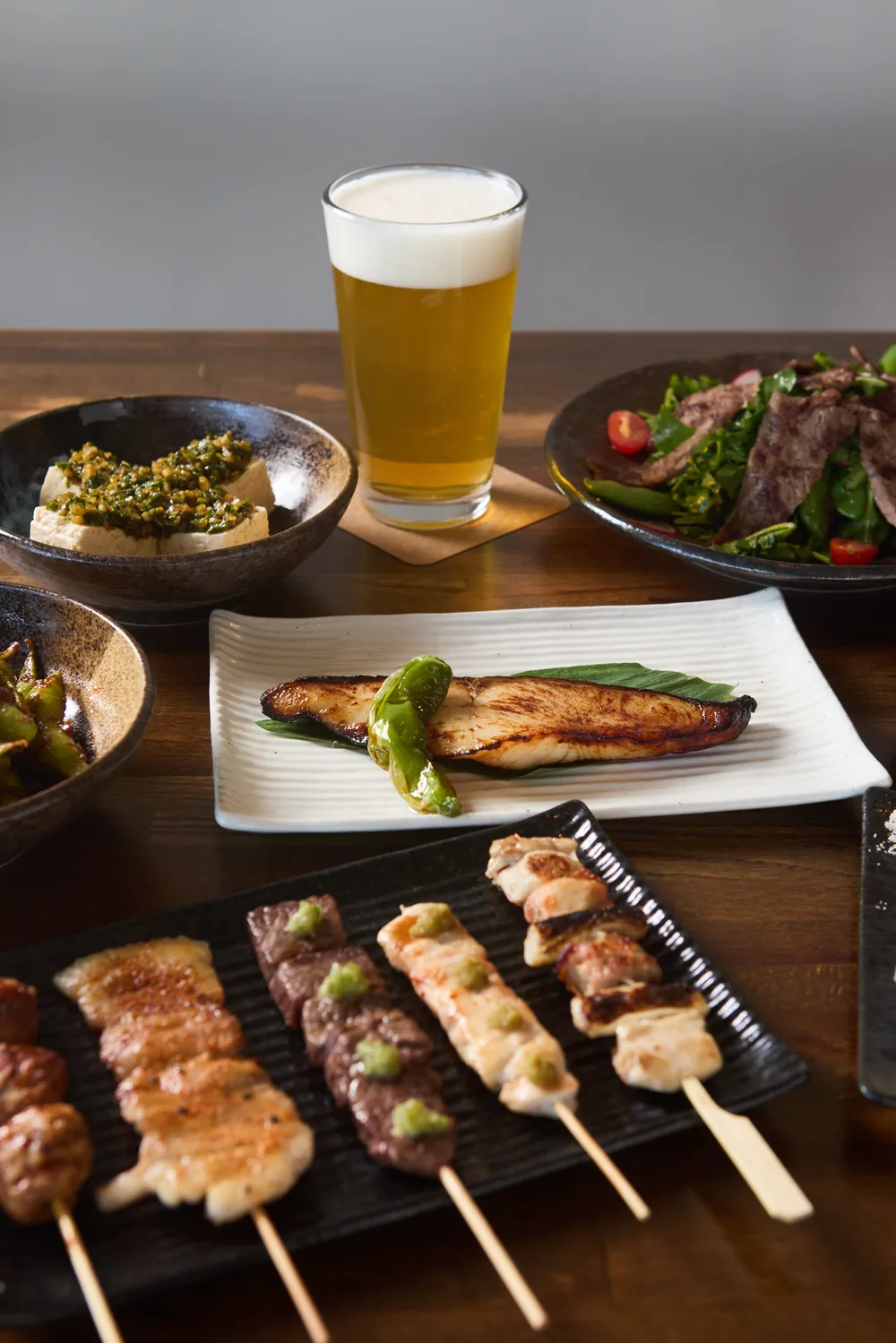 Seafood spread with tempura, sashimi, and sparkling sake