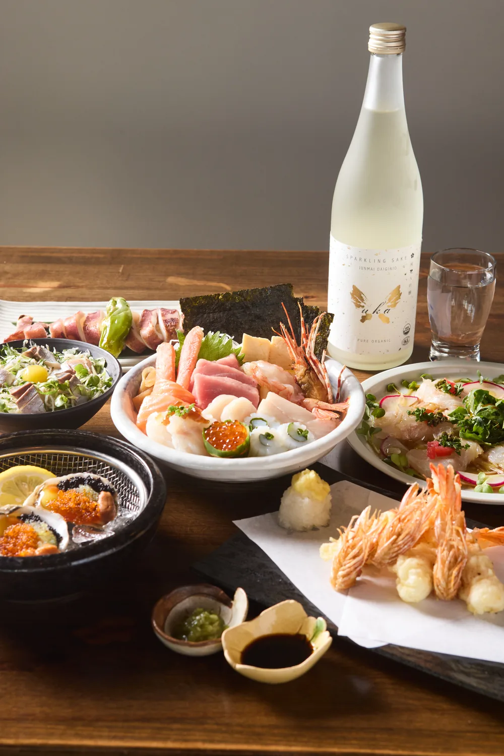 Grilled skewers, miso-glazed cod, salad, beer, and tofu