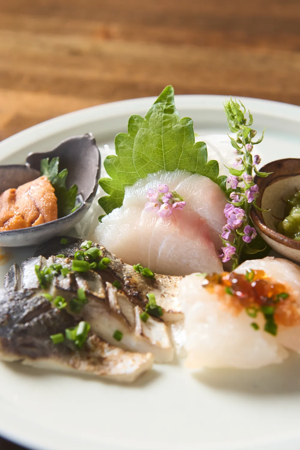 Sashimi plate, close-up with shiso and flowers